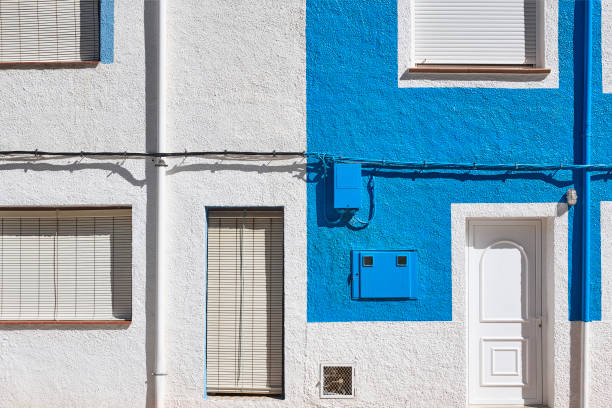istock Blue and white building facade with windows and doors. Geometric 1283841466