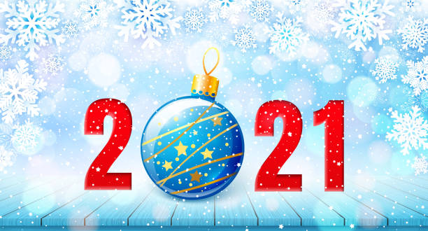 istock Merry Christmas and Happy New Year 2021 banner. Holiday vector illustration with paper snowflakes background, red number and christmas ball on wooden table 1283841764