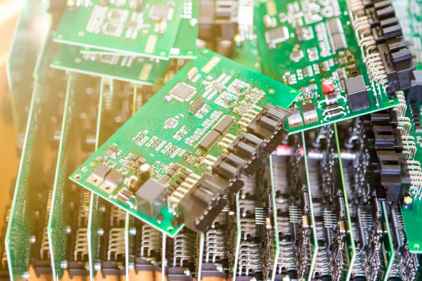 istock Automotive Printed Circuit Boards with Surface Mounted Components. PCb Lying On Top of Batch. Shallow DOF. Lens Flare Added.  Horizontal Image 1283843260