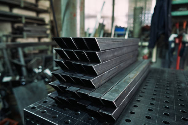 istock Metal pipes stacked in a row on a table at metal workshop 1283843355