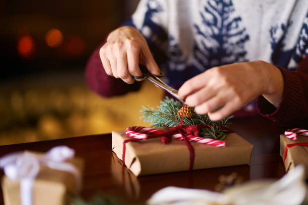 istock Men's hands hold gift box with a red ribbon. New Year's gift. 1283843467