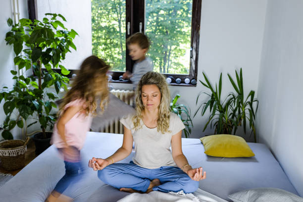 istock While noisy kids running young mother meditates 1283844557