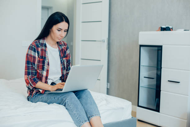 istock Calm woman working online from her bedroom 1283844760