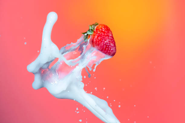 istock Milk Splashes Around Strawberry Fruit. Against Red Background.Horizontal Image 1283844777