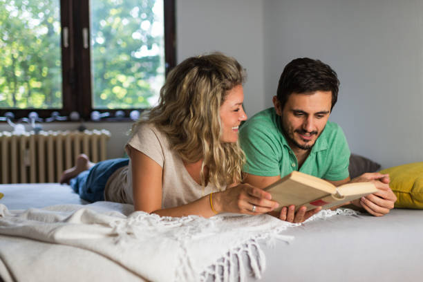 istock Young couple enjoying book together 1283845540