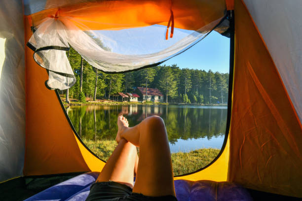 istock Woman reading a book in tent 1283845829