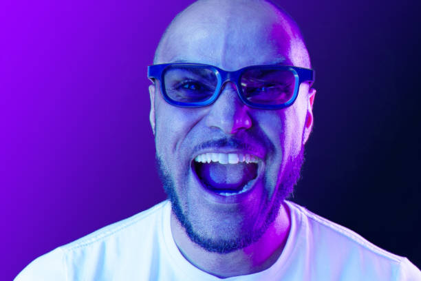 istock Positive black man in glasses posing in neon lights 1283846047