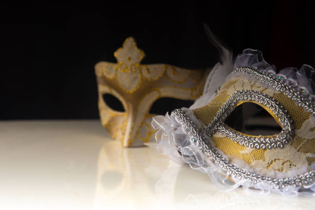 istock Carnival venetian masks on black surface, low key image, directed light, selective focus. 1283846106