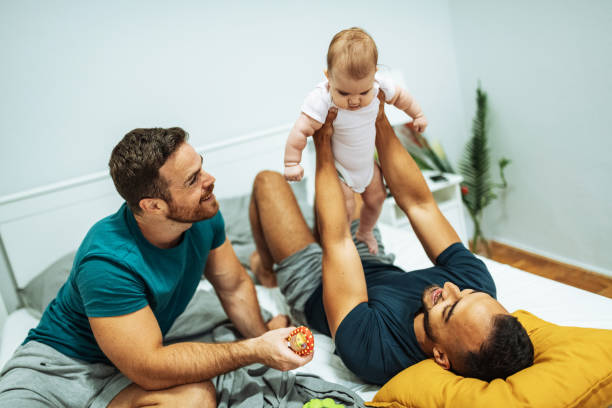 istock LGBT couple with adopted caucasian baby 1283846797