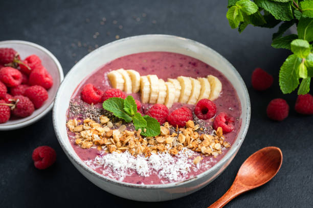 istock Pink smoothie bowl with raspberry, banana, granola and coconut 1283847008