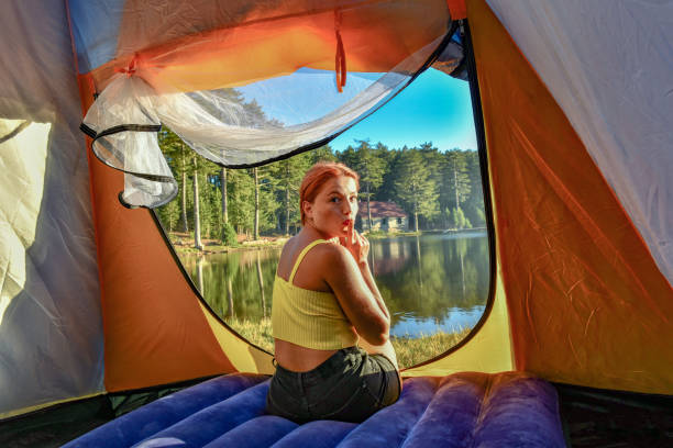 istock Woman reading a book in tent 1283847192