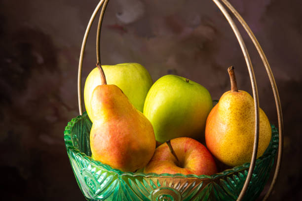 istock Apples and pears arranged in an old fruit bowl, spotted background, selective focus. 1283847416