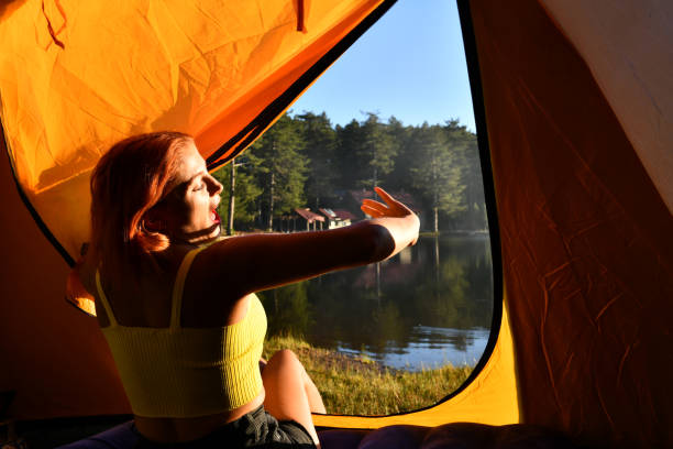 istock Woman reading a book in tent 1283848129
