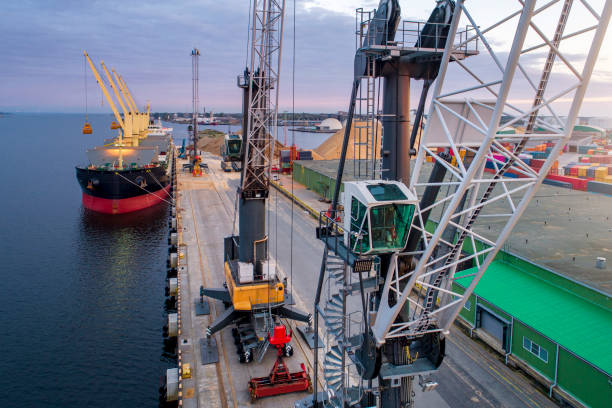 istock Port area with ships, metal containers and large metal cranes for loading cargo. 1283848375