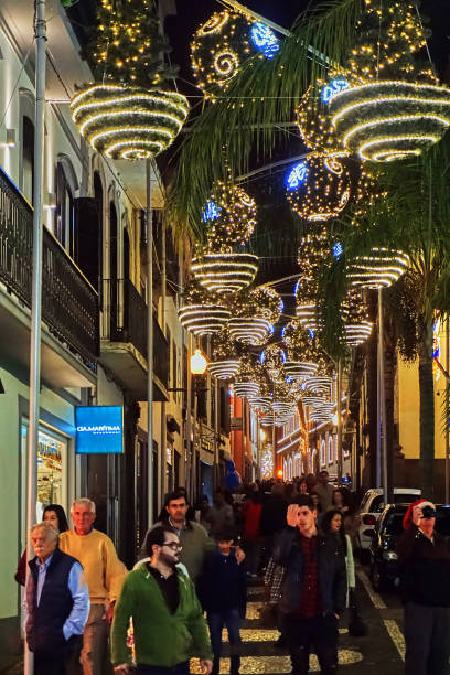 Christmas Funchal, Portugal - December 23, 2018: people walk through the Christmas decorated streets of Funchal on Madeira Island. funchal christmas stock pictures, royalty-free photos & images