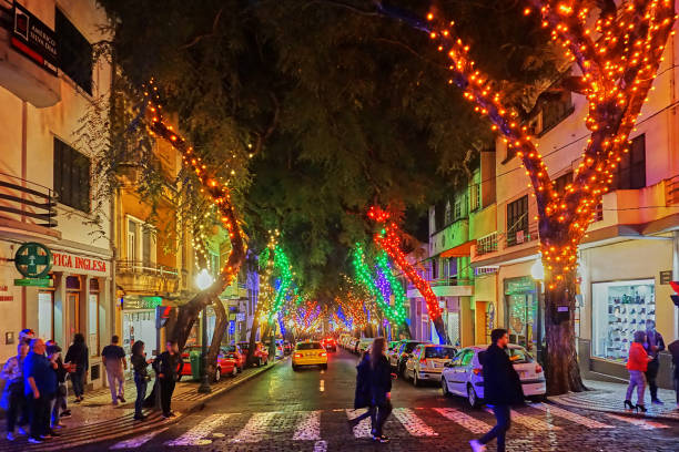 Christmas Funchal, Portugal - December 23, 2018: people walk through the Christmas decorated streets of Funchal on Madeira Island. funchal christmas stock pictures, royalty-free photos & images