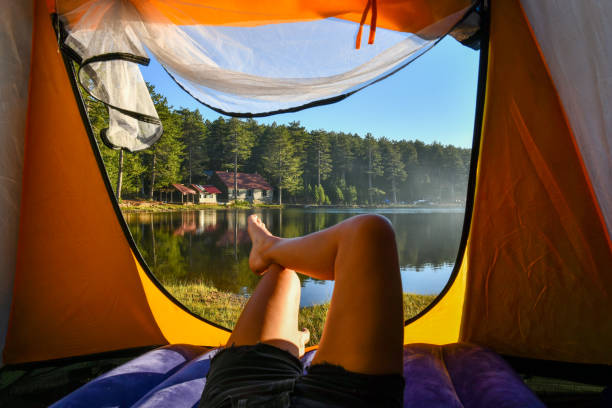 istock Woman reading a book in tent 1283850883