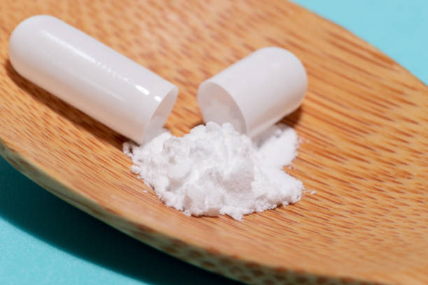 istock open pill with medicine in a wooden spoon 1283850923