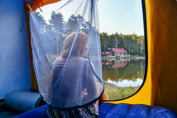 istock Woman reading a book in tent 1283850949