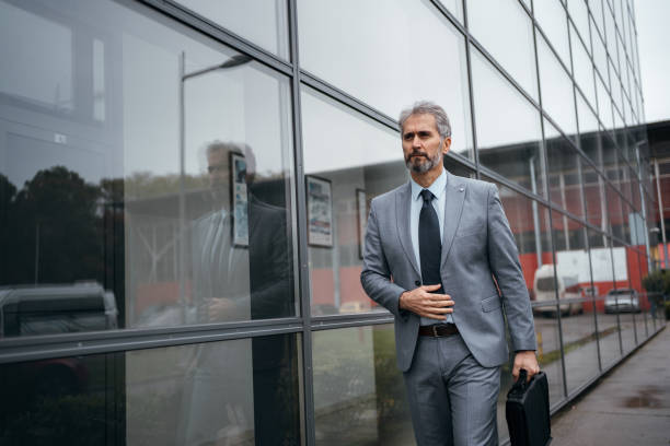 istock Businessman walking along modern building 1283851072