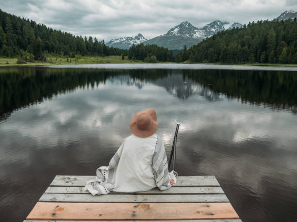 istock Young woman relaxing on lake pier 1283851232