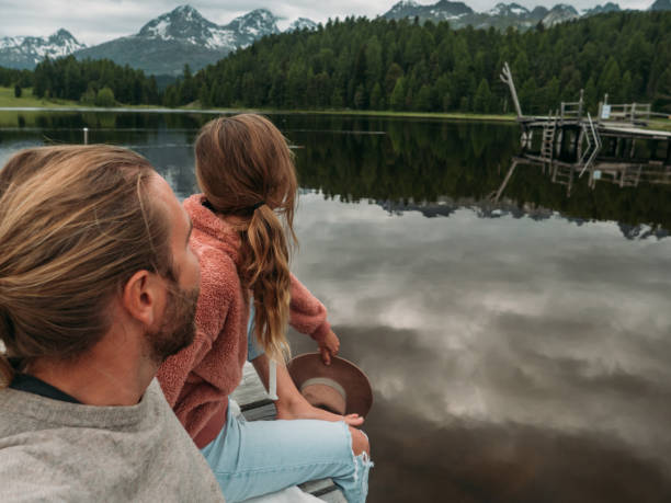istock Couple relaxing on lake pier 1283851285
