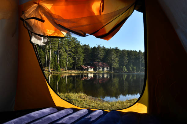 istock Woman reading a book in tent 1283851286