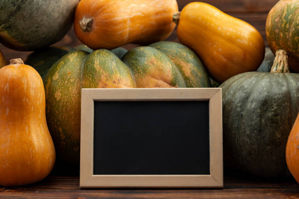 istock Little blackboard in frame against pile of pumpkins 1283851347