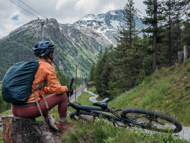 istock Mountain biker on dirt trail looking at landscape 1283851349
