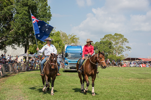 Darwin, NT, Australia-July 27,2018: People riding horses with an Australian flag and spectators at the Darwin Show Day in the NT