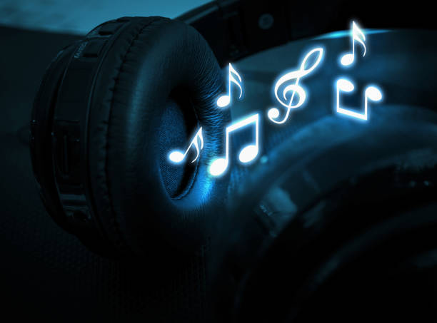 istock Black wireless headphones and notes with a neon glow close up 1283851577