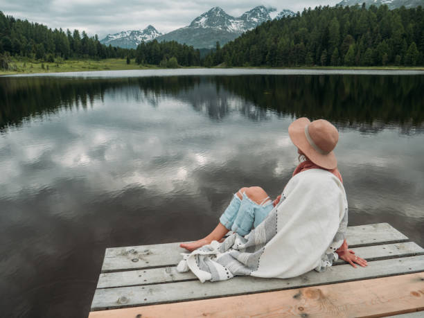 istock Young woman relaxing on lake pier 1283852134