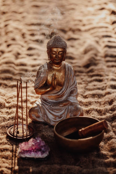 istock Golden Buddha figurine with incense, gong and amethyst 1283852249
