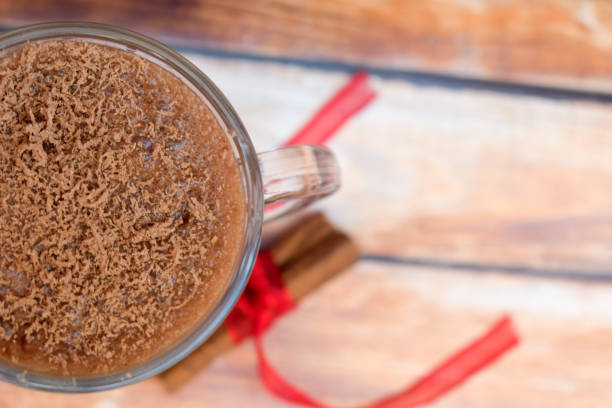 istock Hot chocolate with sprinkles and cinnamon sitcks on a wooden table 1283852407