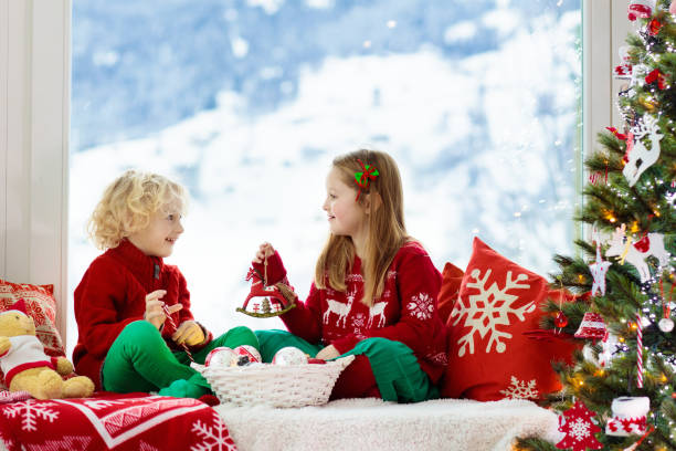 istock Kids decorate Christmas tree. Child on Xmas eve. 1283854974