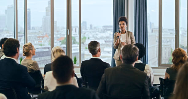 istock Young, mixed race businesswoman delivering a speech during a conference. Q&A panel 1283855203