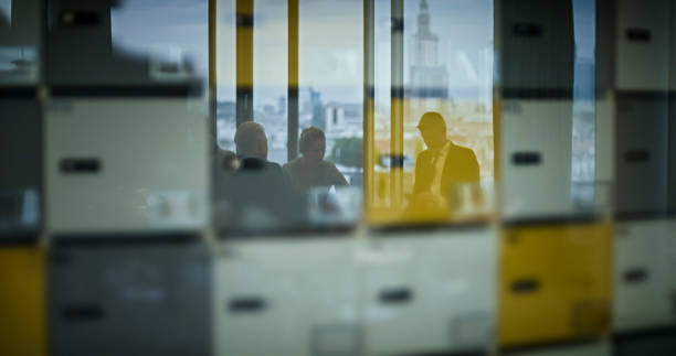 Moving reflections of people on the window. Modern office