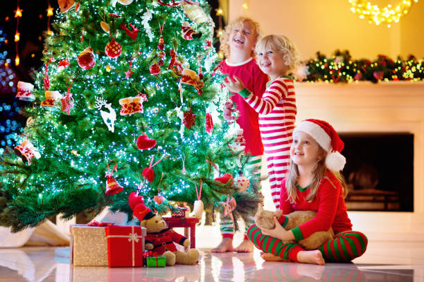 istock Child decorating Christmas tree. Kid on Xmas eve. 1283855543