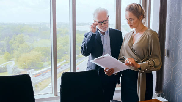 istock Mature businessman working with businewoman. Board room 1283855768