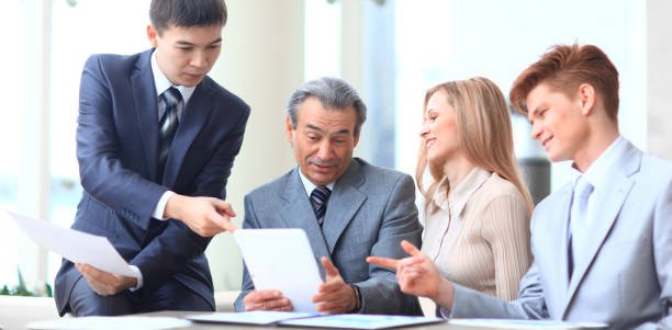 istock chief and business team discussing business documents. close up 1283856474