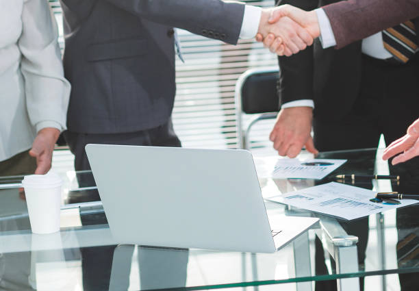 istock close up. business partners meeting each other with a handshake 1283856798