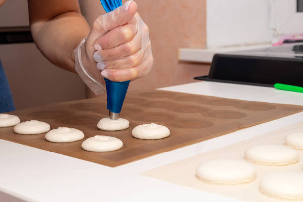istock On parchment spread the dough for macaroons from the pastry bag before baking. Cooking process. 1283857111