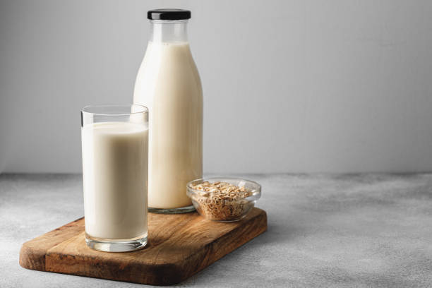 istock Vegan oat milk with oat flakes close up 1283857348