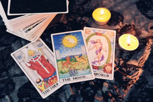 Tarot cards by candlelight on dark background fortune card prophecy, gypsy card for fortune teller reading future.