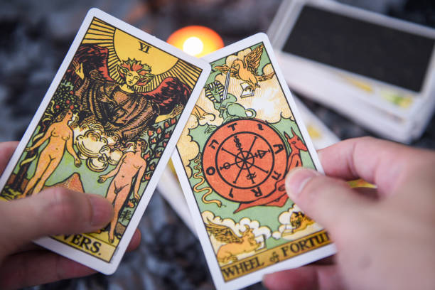 istock Fortune teller using tarot cards reading future by candlelight on dark background fortune card prophecy gypsy card 1283858516