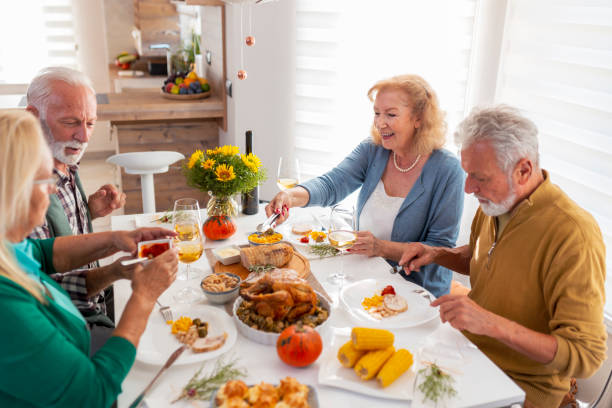 istock Senior friends having Thanksgiving dinner 1283858543