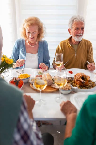 istock Elderly friends having Thanksgiving dinner 1283859255