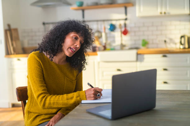 istock Mature woman working on laptop at home 1283860095