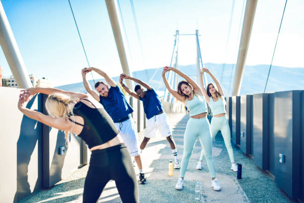 istock Multi Ethnic Fitness Group Stretching With Fitness Instructor 1283860671