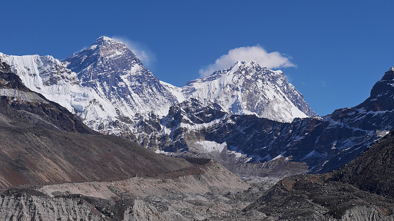 Beautiful panorama view of majestic Mount Everest (also Sagarmatha, summit 8,848 m) including South Col and Hillary Step with rock-covered Ngozumpa glacier viewed from upper Gokyo valley, Nepal.